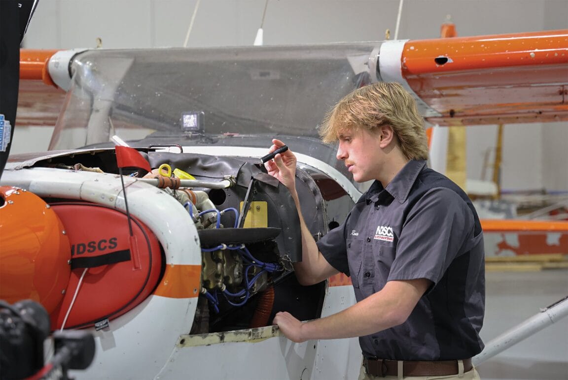 NDSCS aviation student working on an aircraft