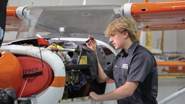 NDSCS aviation student working on an aircraft